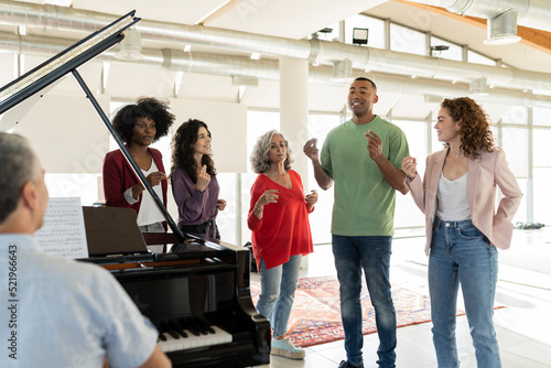 Businessman singing by colleagues snapping fingers