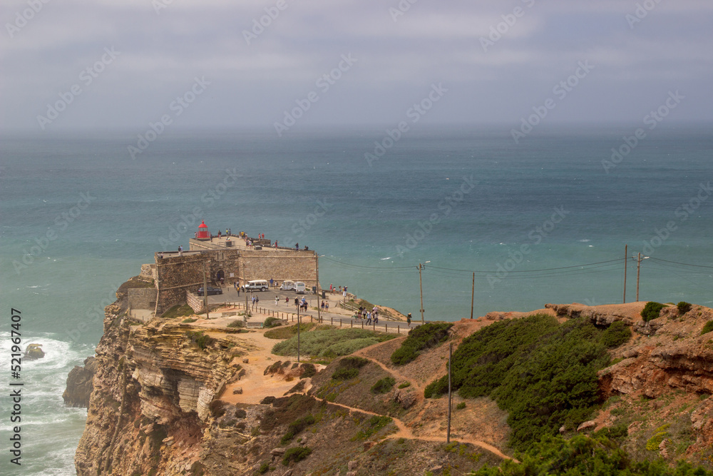 Fort at seaside of Portugal, Nazare. Lighthouse on the rocky cliff