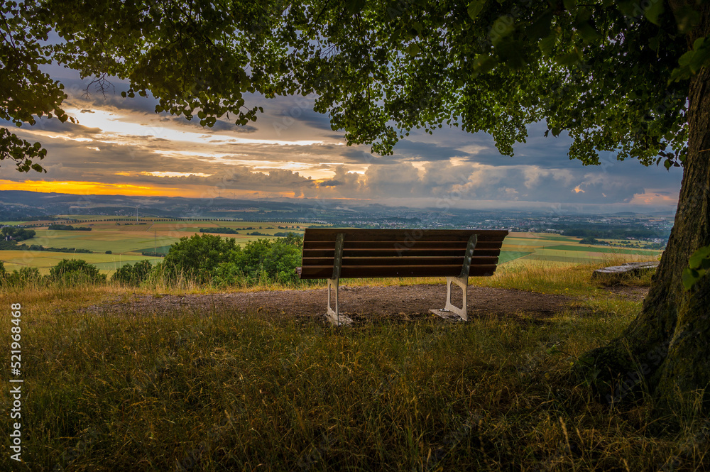 Empty bench on land at sunset Mensfelder Kopf, Hesse, Germany Empty bench on land at sunset Mensfelder Kopf, Hesse, Germany