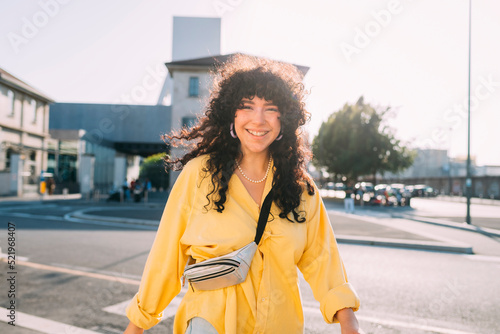 Happy woman walking on street in city photo