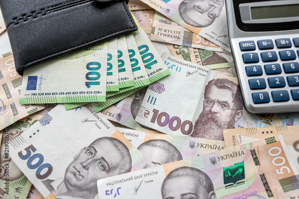 exchange concept euro bills in purse with calculator lying on euro banknotes background exchange concept euro bills in purse with calculator lying on euro banknotes background