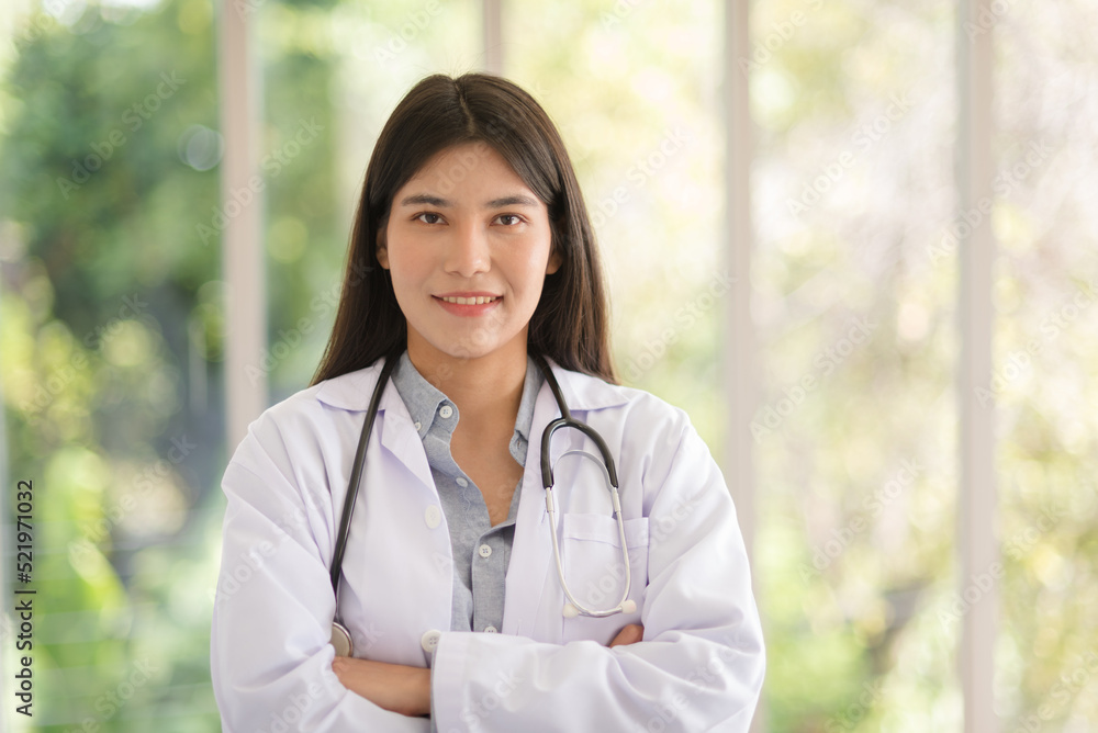 Asian doctor woman portrait in professional uniform standing with smile and confidence.