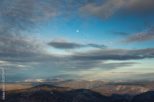 The winter mountains of Siberia have been transformed into impressive landscapes thanks to the blue beautiful sunset.