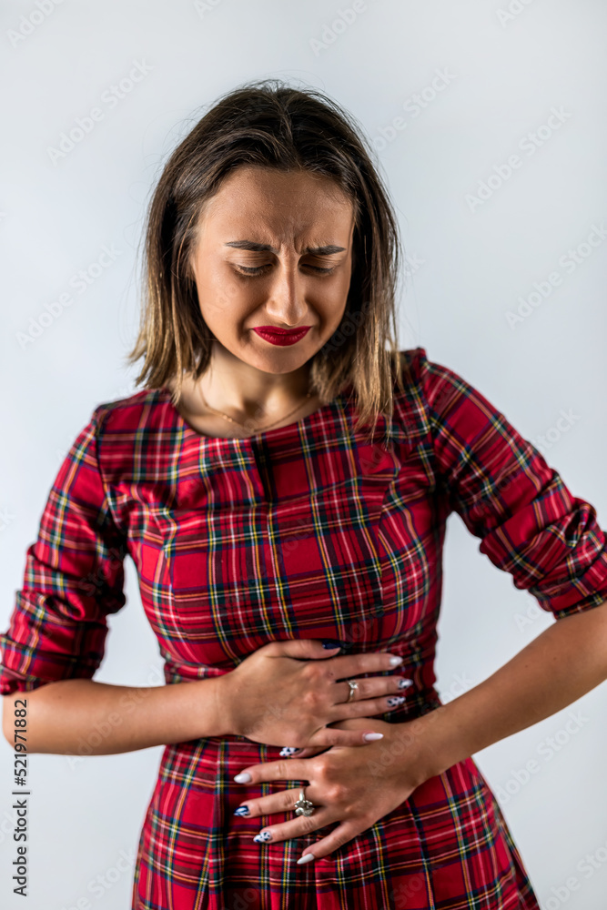 beautiful young girl holds her stomach, which has spasms. beautiful young girl holds her stomach, which has spasms.