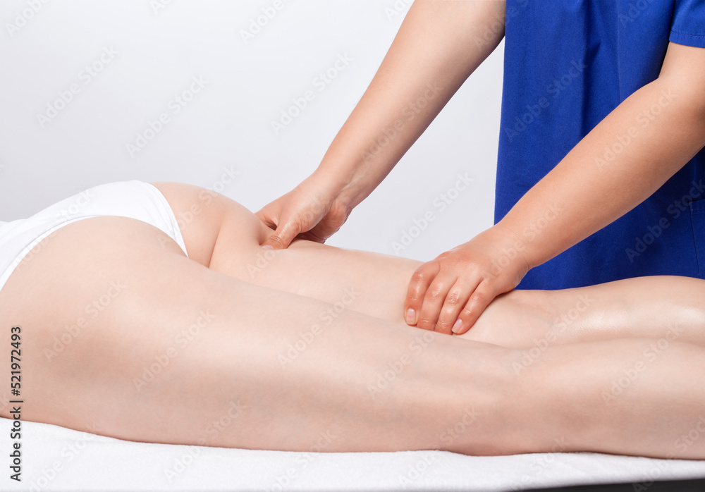 Masseur makes anti-cellulite massageon the legs, thighs, hips and buttocks in the spa. Overweight treatment, body sculpting.Cosmetology and massage concept. Masseur makes anti-cellulite massageon the legs, thighs, hips and buttocks in the spa. Overweight treatment, body sculpting.Cosmetology and massage concept.