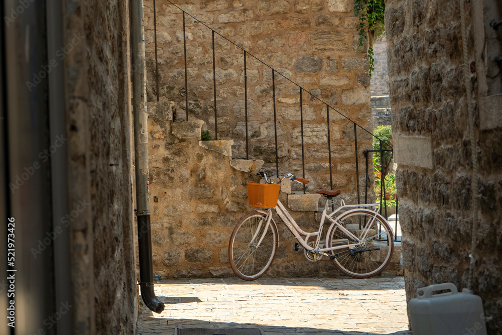 old fashioned bicycle next to stone stairs on narrow streets of old town