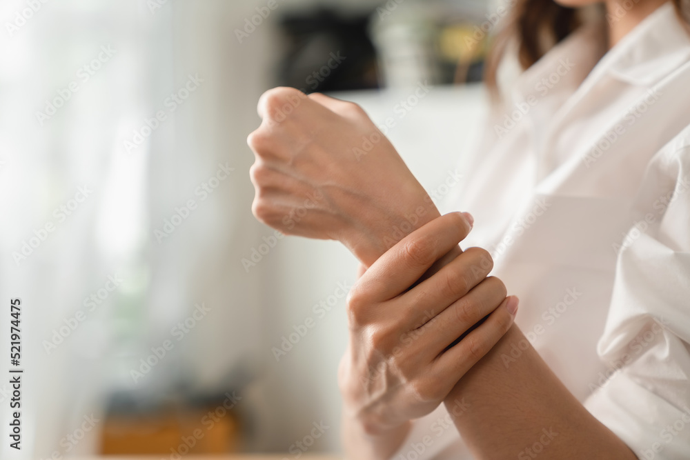 Close up of unhappy young woman having wrist pain in hand, Office Syndrome and chronic disease from injury. Close up of unhappy young woman having wrist pain in hand, Office Syndrome and chronic disease from injury.