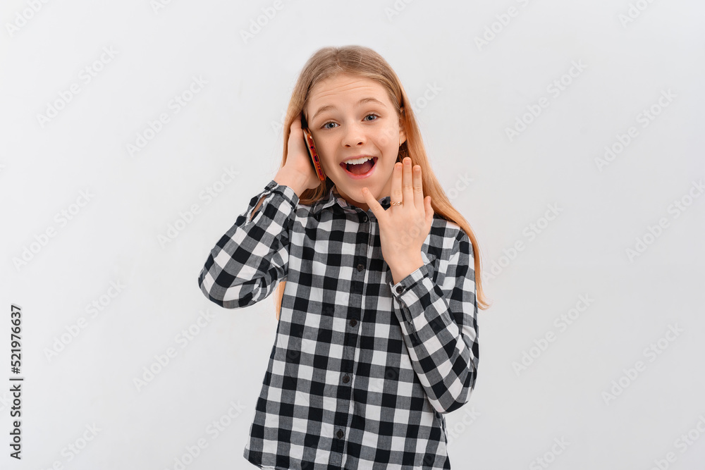 Portrait of happy modern teen girl using mobile phone, chatting in app, standing in casual shirt over white background Portrait of happy modern teen girl using mobile phone, chatting in app, standing in casual shirt over white background