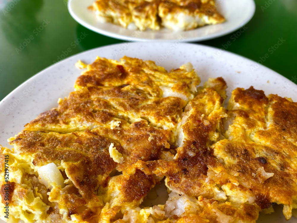 Fried carrot cake, aka fried turnip or radish cake, is a popular local breakfast or snack food in Singapore and Malaysia. This is the white version, where the egg coating dish is slightly crispy. Fried carrot cake, aka fried turnip or radish cake, is a popular local breakfast or snack food in Singapore and Malaysia. This is the white version, where the egg coating dish is slightly crispy.