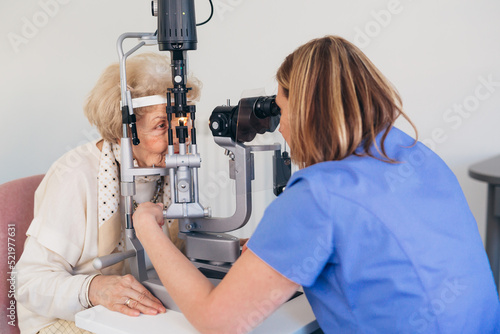 senior woman checking her eyesight in clinic photo