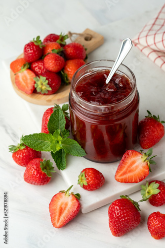 strawberry jam in glass jar and fresh strawberries