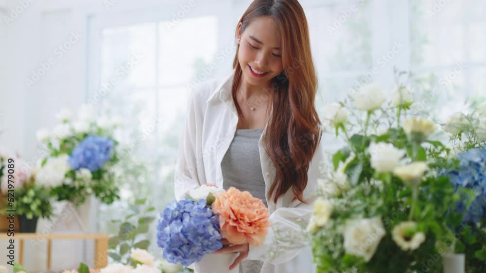 Small business,business online and New market concept.Young florist female use smartphone take photo bouquet of flower send to customer at workplace.woman artist working in flower shop studio at home Small business,business online and New market concept.Young florist female use smartphone take photo bouquet of flower send to customer at workplace.woman artist working in flower shop studio at home