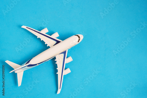 Airplane model blue background.Concept travel and recreation.