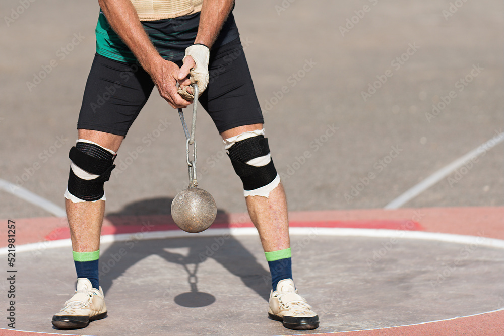 An athlete competing in the hammer throw event, athlete performing a