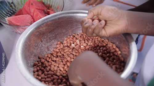 Removing stones or bad peanuts or groundnuts in preparation for frying or roasting them photo