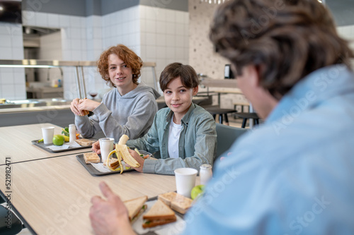 Boys having lunch in a school canteen