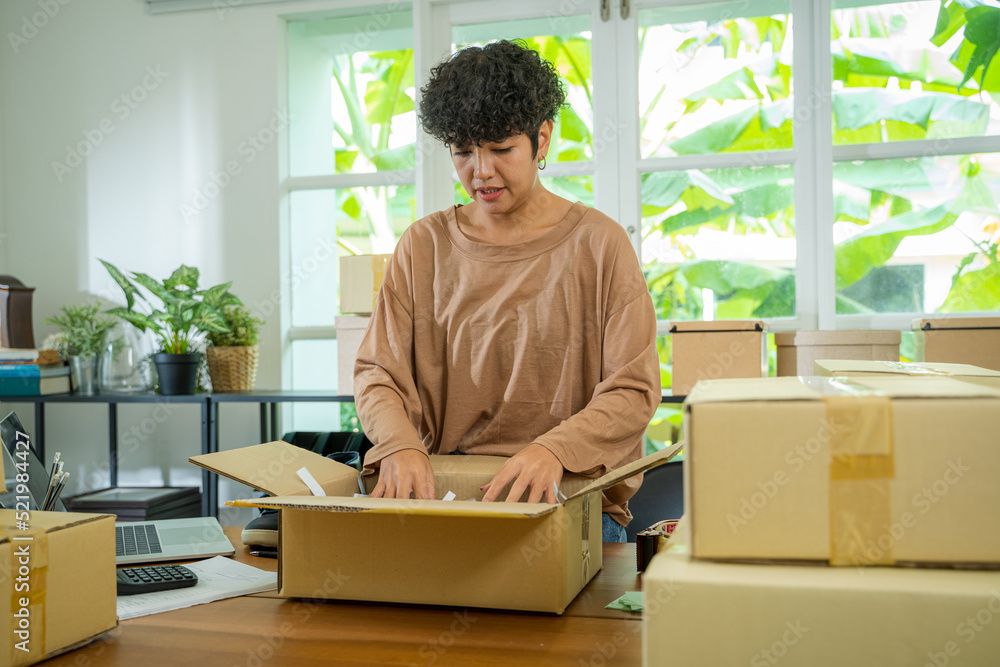 Owners female entrepreneurs check online orders to prepare to pack the boxes,Online marketing packaging box and delivery,SME concept. Owners female entrepreneurs check online orders to prepare to pack the boxes,Online marketing packaging box and delivery,SME concept.