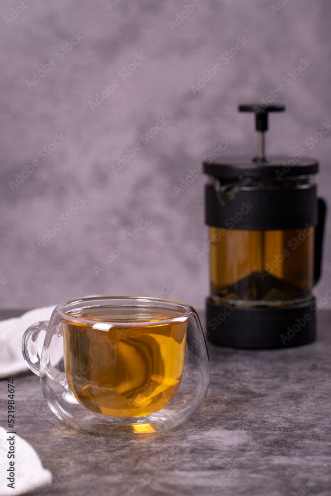 Green tea. Green tea brewed with French press on a dark background. Healthy drinks. Herbal tea concept. close up Green tea. Green tea brewed with French press on a dark background. Healthy drinks. Herbal tea concept. close up