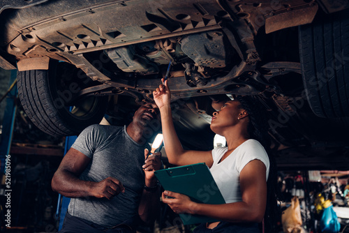 Auto mechanic are checking and repair maintenance auto engine is problems at car repair shop.