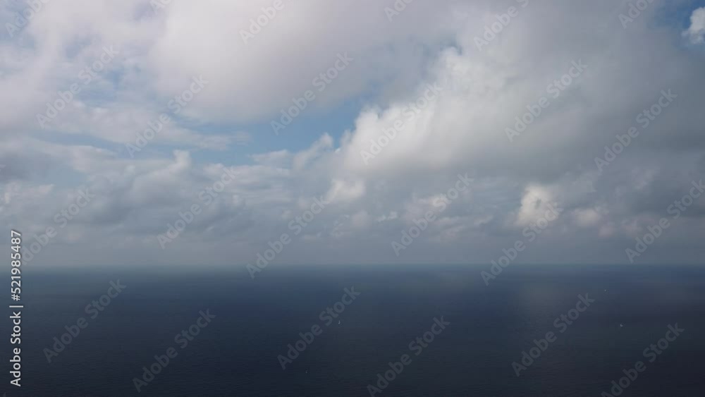Aerial view. Blue sky sun and fog over calm sea. The drone flies over foggy and fluffy clouds. Abstract aerial nature summer ocean sunset sea and sky background. Vacation, travel and holiday concept. Aerial view. Blue sky sun and fog over calm sea. The drone flies over foggy and fluffy clouds. Abstract aerial nature summer ocean sunset sea and sky background. Vacation, travel and holiday concept.
