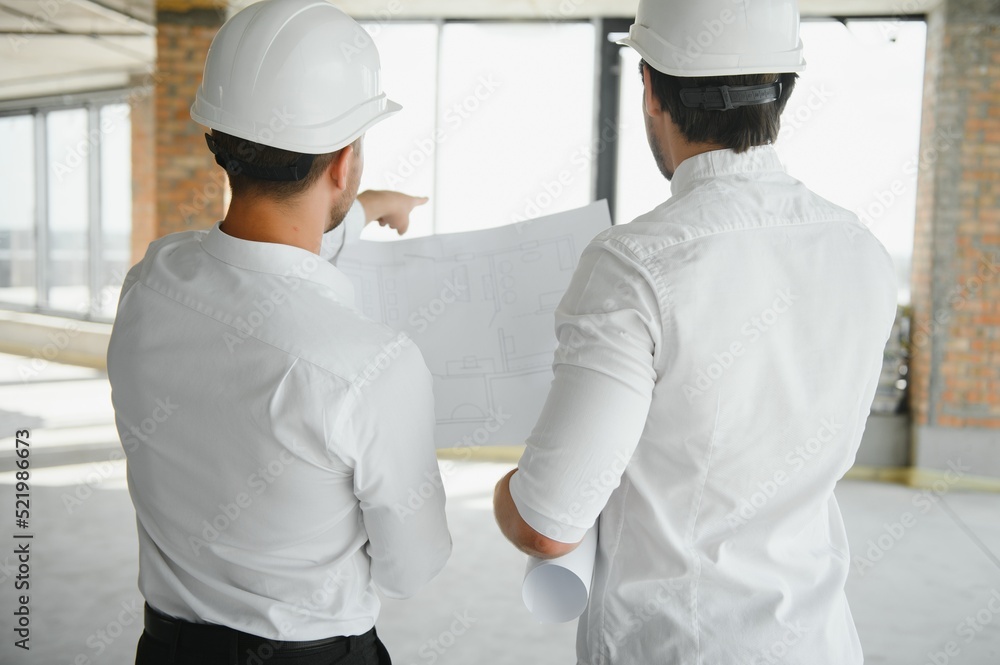 Two young man architect on a building construction site Two young man architect on a building construction site