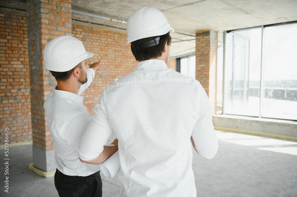 Two young man architect on a building construction site Two young man architect on a building construction site