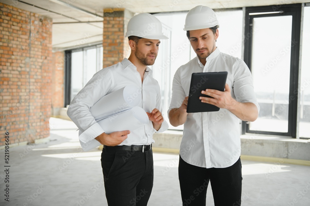 Two young man architect on a building construction site Two young man architect on a building construction site