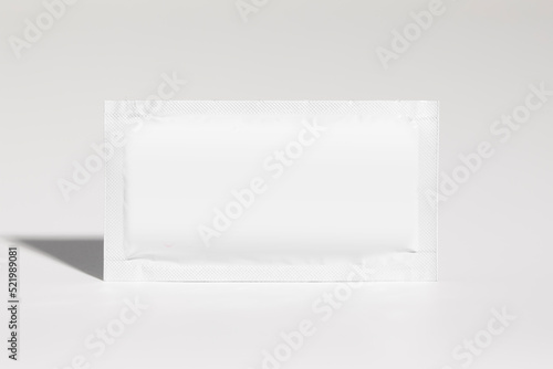 Mockup of isolated envelope of medicine, for powder, horizontal, with blank label for packaging design, on white background, real photo studio, no 3D