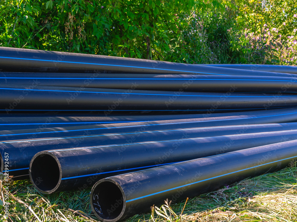 Large diameter plastic pipes for outdoor water supply. HDPE pipes lie
