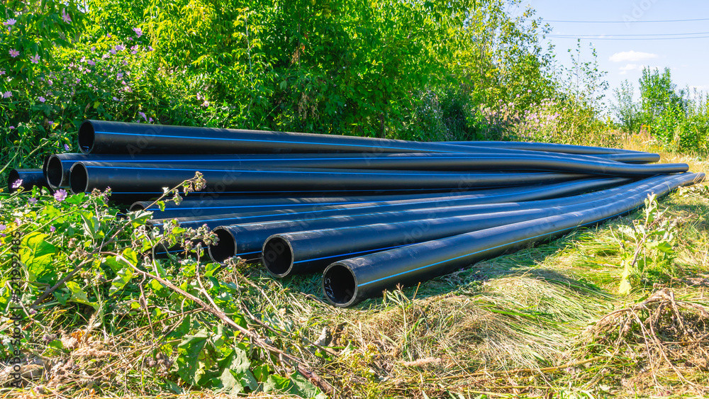 Large diameter plastic pipes for outdoor water supply. HDPE pipes lie