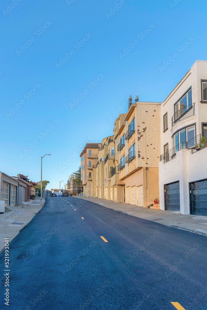 Asphalt road with yellow broken lines in a residential area at San Francisco, California Asphalt road with yellow broken lines in a residential area at San Francisco, California