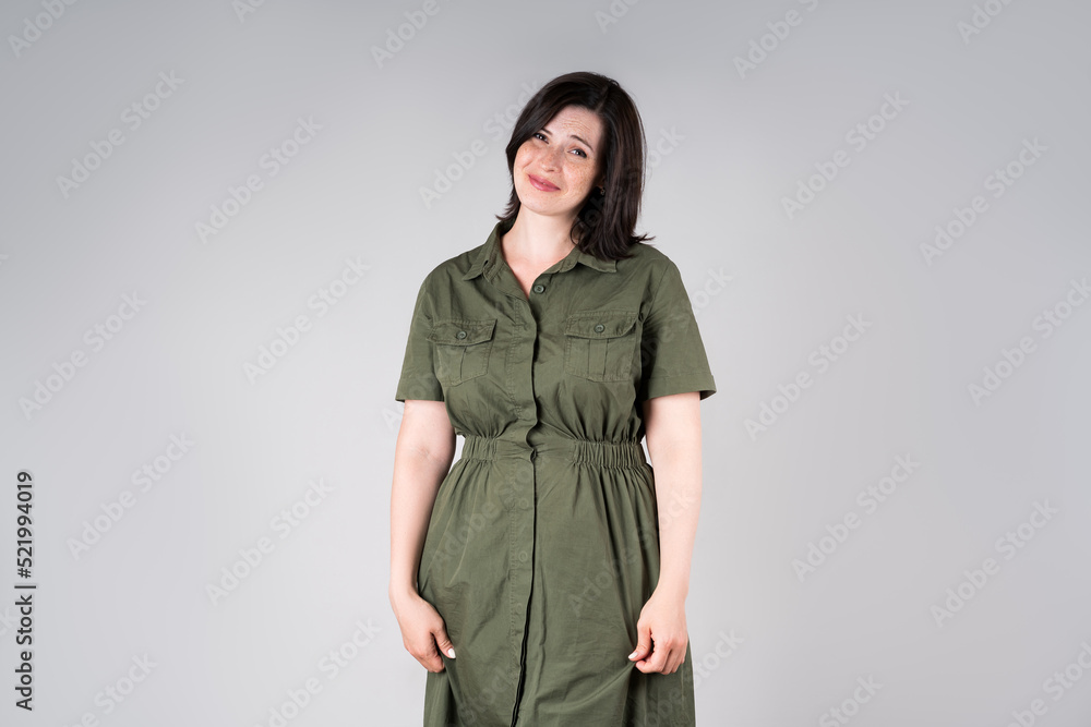 Confused plus size model in casual clothes, fat woman on gray background, overweight female body Confused plus size model in casual clothes, fat woman on gray background, overweight female body