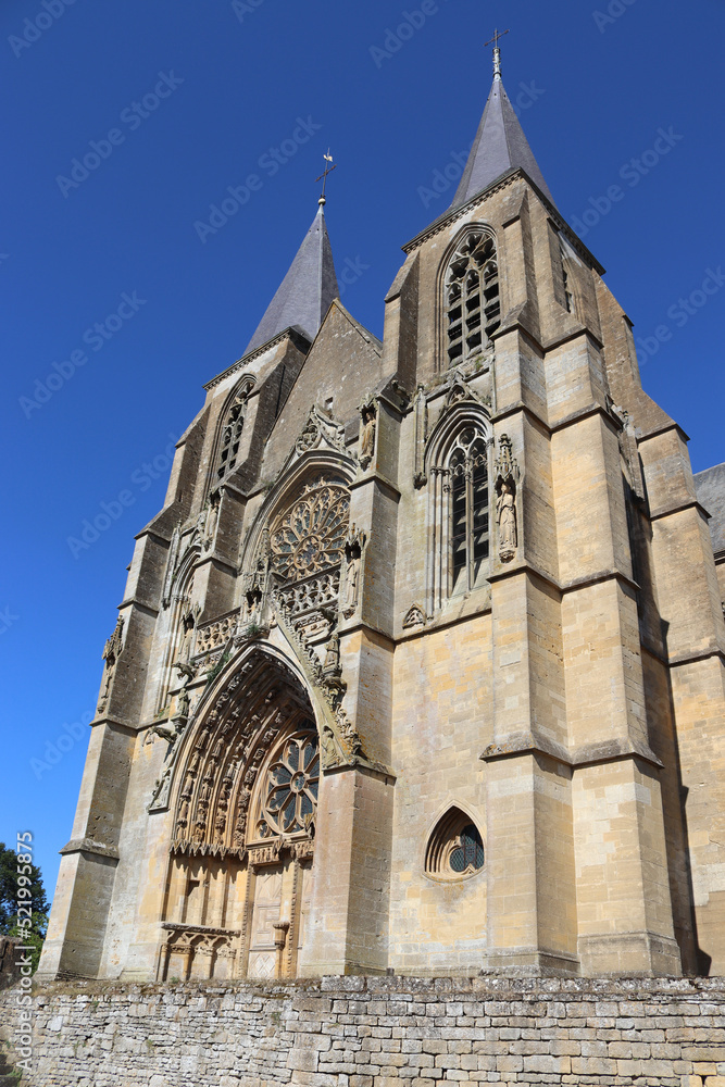 Exterior view of the beautiful gothic style Basilica of Notre Dame of Avioth. Located in the region of Grand Est France, summer view with clear sky.
