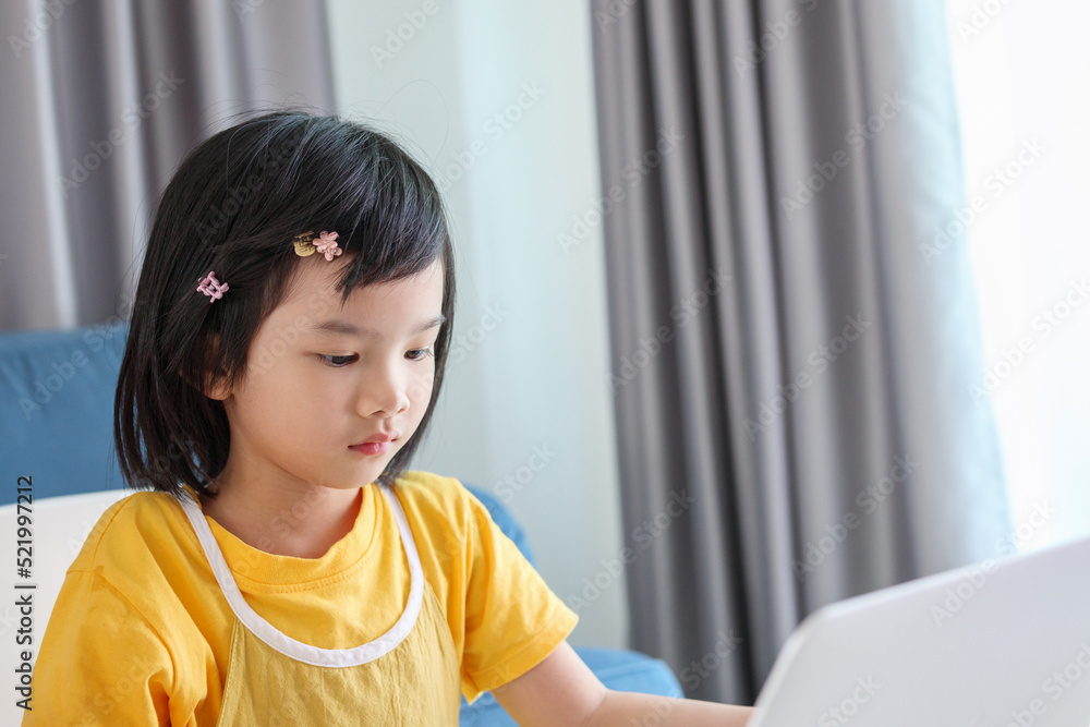 little asian girl student study online using laptop computer at home little asian girl student study online using laptop computer at home