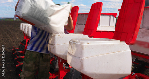 Farmer Fills up Sunflower Seeds Tractor Seeding Machine Field Seeder Rural Working Combine Tillage Agricultural Equipment Season Sowing Grain Spring time Process Planting Agriculture Farm