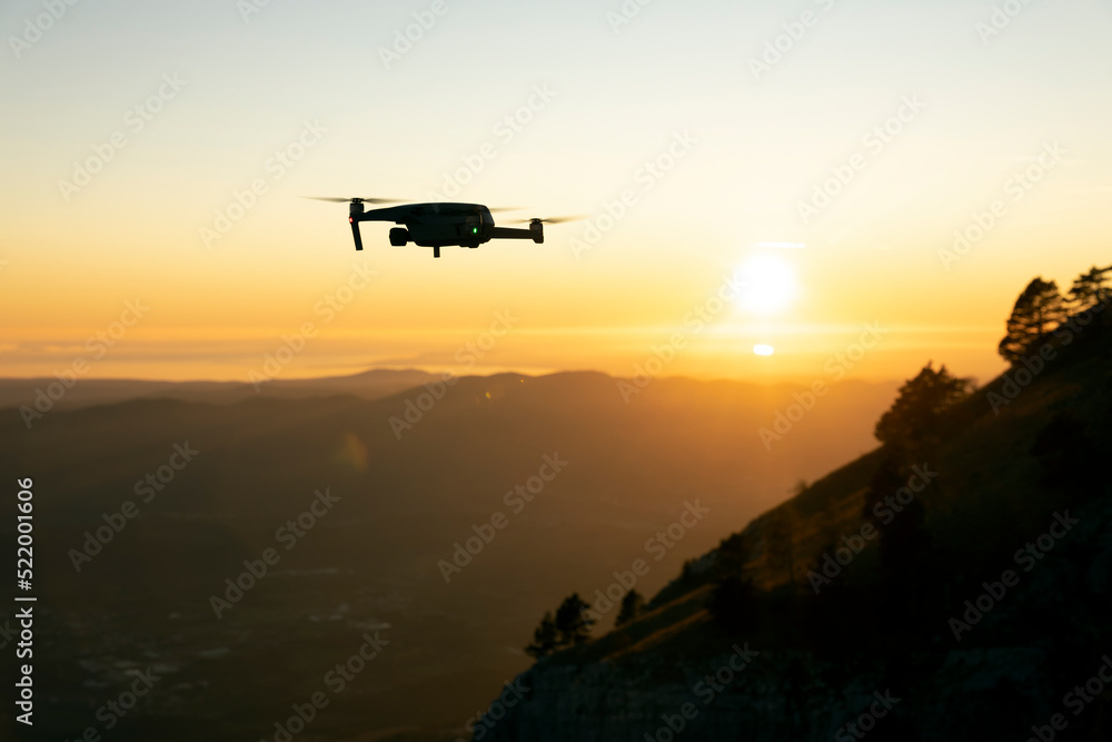 Drone in Flight at Sunset Over a Valley