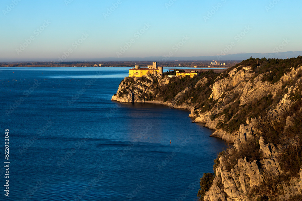 Devin - Duino Castle on Adriatic Sea Coast in First Morning Lights of Winter Devin - Duino Castle on Adriatic Sea Coast in First Morning Lights of Winter