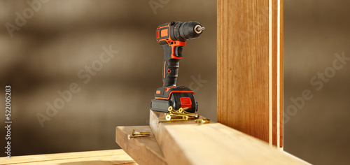 Black and orange drill and workshop interior. 