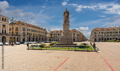 Cuneo, Piedmont, Italy - August 06, 2022: Statue of Giuseppe Barbaroux in the center of the Tancredi Duccio Galimberti square, in the background the beginning of corso Nizza