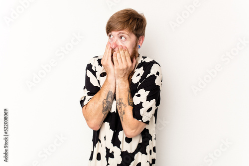 Young caucasian red-haired man isolated on white background scared and afraid.