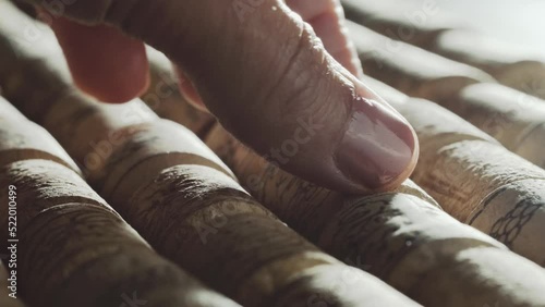 Female hand picking one wine cork stopper from Aligned rows of cork stoppers, Slow motion photo