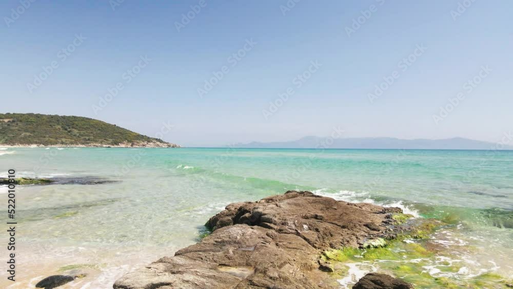 4K drone clip flying low over golden sand and rocks in a tropical beach in Greece 4K drone clip flying low over golden sand and rocks in a tropical beach in Greece