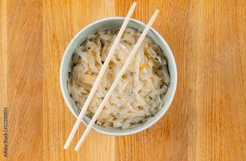 noodle with chopsticks on wooden tray from top