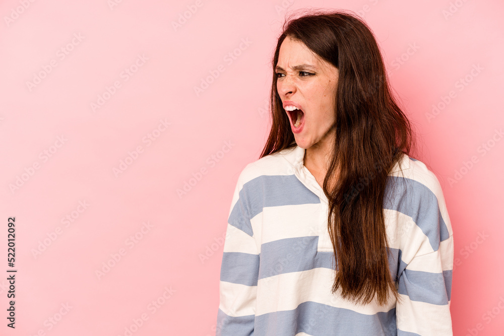 Young caucasian woman isolated on pink background shouting very angry, rage concept, frustrated. Young caucasian woman isolated on pink background shouting very angry, rage concept, frustrated.