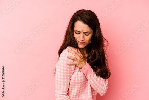 Young caucasian woman isolated on pink background having a shoulder pain. © Asier