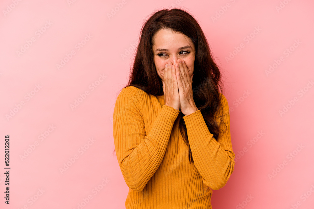 Young caucasian woman isolated on pink background laughing about something, covering mouth with hands. Young caucasian woman isolated on pink background laughing about something, covering mouth with hands.