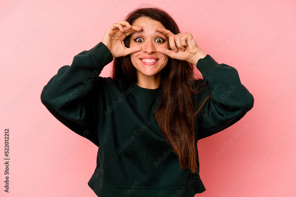 Young caucasian woman isolated on pink background keeping eyes opened to find a success opportunity. Young caucasian woman isolated on pink background keeping eyes opened to find a success opportunity.