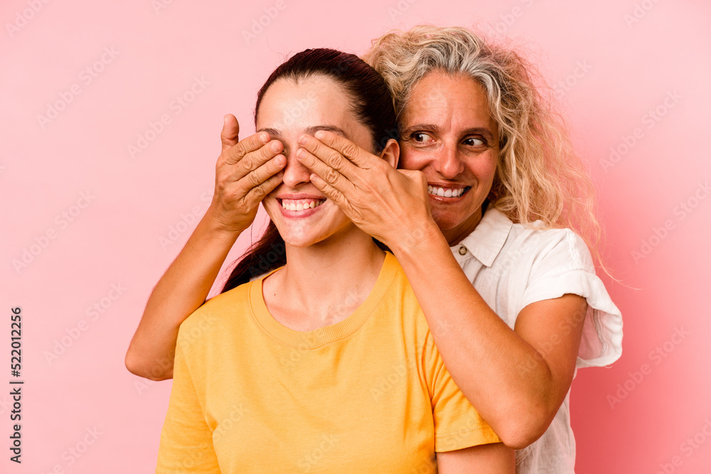 Caucasian mom and daughter isolated on pink background Caucasian mom and daughter isolated on pink background
