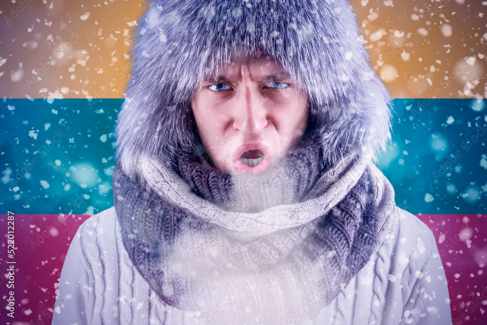 Isolate. Cold weather. Bask. A man in a fur hat and scarf warms his hands with his mouth. It's winter time Isolate. Cold weather. Bask. A man in a fur hat and scarf warms his hands with his mouth. It's winter time