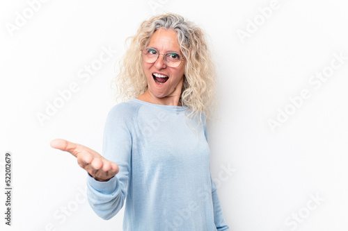 Middle age caucasian woman isolated on white background stretching hand at camera in greeting gesture.